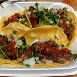 Steak tacos with cilantro and onion. Optional but must-try hot sauce makes this a perfect helping of street tacos.