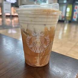 a cup of iced coffee on a table a cup of iced coffee on a table