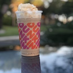 a cup of iced coffee on a table a cup of iced coffee on a table