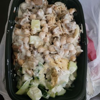Shah's Halal Food - Lamb chunks over delectable rice. I added hummus, chick peas, cucumber, and lots of white sauce. - Halal Near Me - East Meadow, New York