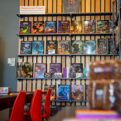 Puddletown Games & Puzzles - This is our Dungeons & Dragons wall of books and accessories.