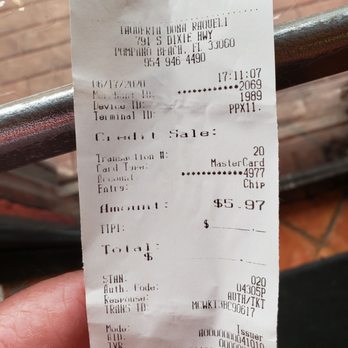 Taquería Doña Raquél - a hand holding a receipt - Mexican Near Me - Pompano Beach, Florida Taquería Doña Raquél - a hand holding a receipt - Mexican Near Me - Pompano Beach, Florida
