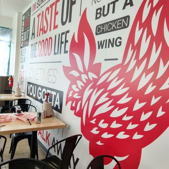 Cluck & Blaze - Reading material on the wall - Chicken Shop Near Me - Long Beach, California Cluck & Blaze - Reading material on the wall - Chicken Shop Near Me - Long Beach, California