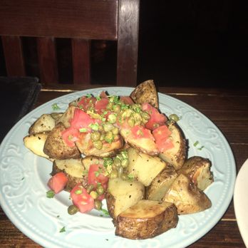 Santiago's Bodega - Potatoes with sauce and Parmesan on the side. Sauce was a little spicey but delicious. - Tapas Bars Near Me - Orlando, Florida Santiago's Bodega - Potatoes with sauce and Parmesan on the side. Sauce was a little spicey but delicious. - Tapas Bars Near Me - Orlando, Florida