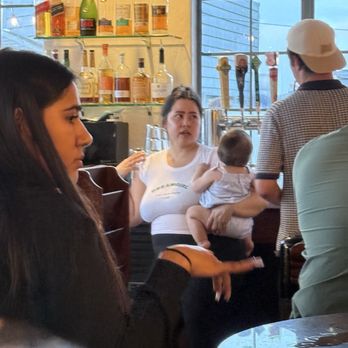 The Anchor Rose - Bartender with a beer and baby in tow behind the bar!!! - New American Near Me - Santa Barbara, California The Anchor Rose - Bartender with a beer and baby in tow behind the bar!!! - New American Near Me - Santa Barbara, California