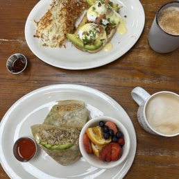 Breakfast burrito with a side of fruit and the eggs Benedict Breakfast burrito with a side of fruit and the eggs Benedict
