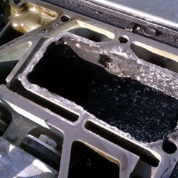 The Boat House Of Cape Coral - Damaged engine from Boat House with JB weld type substance on the block to hide it.