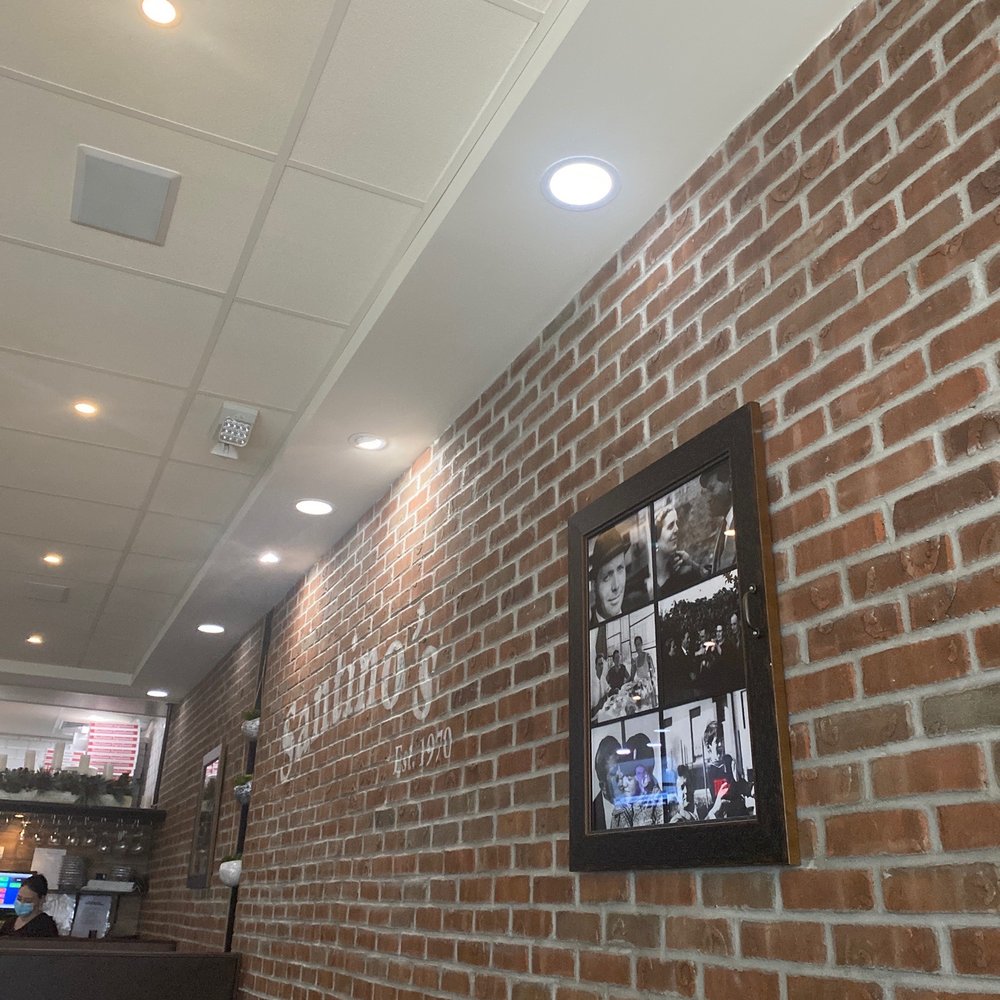 Santino's Pizza - a woman laughing in a restaurant - Pizza Near Me - Parlin, New Jersey Santino's Pizza - a woman laughing in a restaurant - Pizza Near Me - Parlin, New Jersey