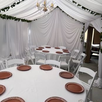 Fiesta D’s - All white draping with greenery and crystal chandeliers - Party Equipment Rentals Near Me