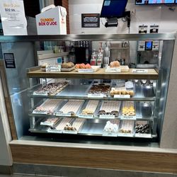 Dunkin' - Display case of muffins, donuts, etc.