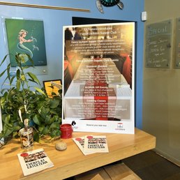 a table with a sign and a plant