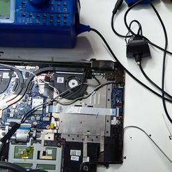 Pocket Pro Tech - A laptop being worked on sitting on an AI generated workbench.