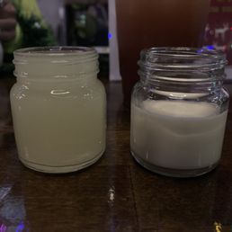 a jar of milk and a jar of sugar on a table a jar of milk and a jar of sugar on a table