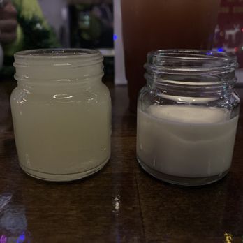 Pau Hana - a jar of milk and a jar of sugar on a table - Coffee & Tea Near Me - West Melbourne, Florida Pau Hana - a jar of milk and a jar of sugar on a table - Coffee & Tea Near Me - West Melbourne, Florida
