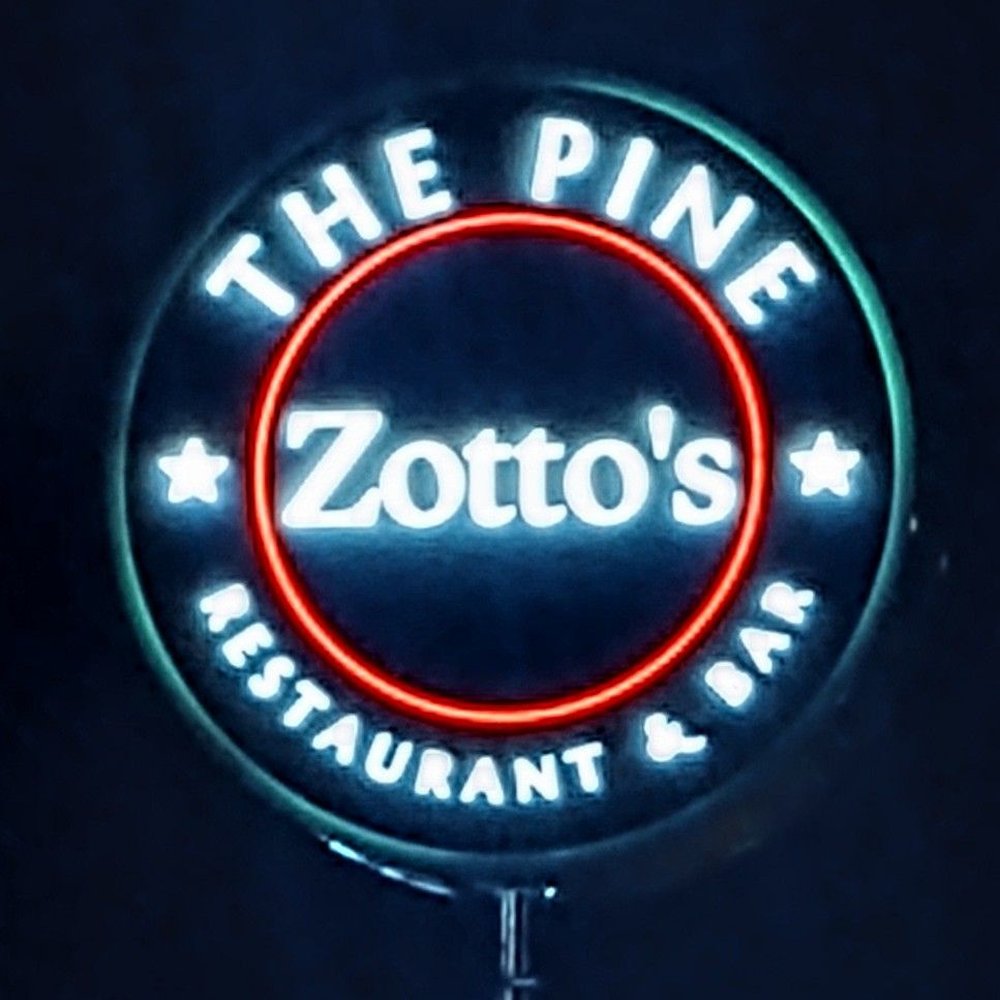 a neon sign for zota's restaurant and bar a neon sign for zota's restaurant and bar