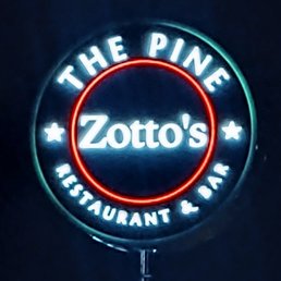 a neon sign for zota's restaurant and bar