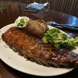 Full rack of baby back ribs with baked potato and broccoli
