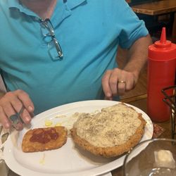 The Cubbard - That's the tenderloin with what my husband said was exceptional, sausage gravy, and the hashbrowns as you can see is those patties