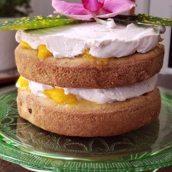Beeside Cottage Cakery - Vanilla coconut cake topped&filled with fresh mangoes & coconut whipped cream - Custom Cakes Near Me Beeside Cottage Cakery - Vanilla coconut cake topped&filled with fresh mangoes & coconut whipped cream - Custom Cakes Near Me