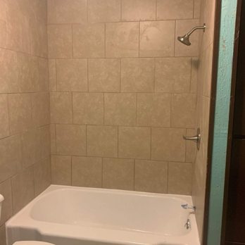Epperson Construction - a bathtub and toilet in a bathroom - General Contractors Near Me