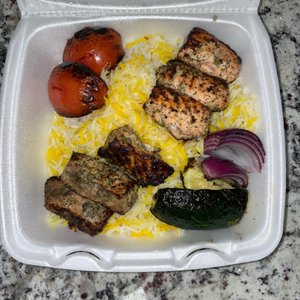 Photo of Sorrento Grill - Herndon, VA, United States. Grilled Salmon Kabob, rice, tomatoes, cucumber