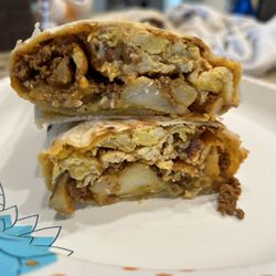 Hola' Tacos - San Juan Breakfast Burrito: potatoes, onions, eggs, cheese, bacon , chorizo and Hatch Green Chile!
