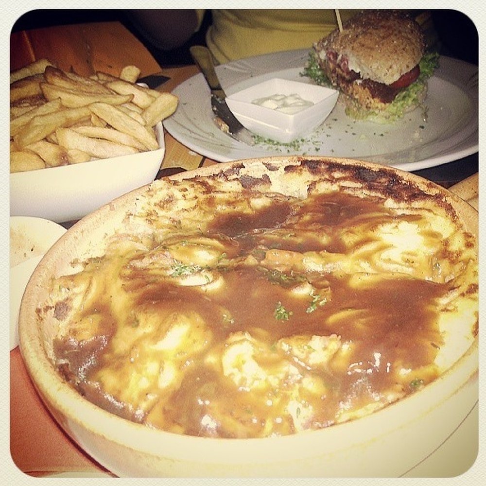 Cottage pie in foreground and veggie burger in the background. Cottage pie in foreground and veggie burger in the background.