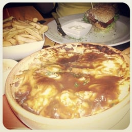 Cottage pie in foreground and veggie burger in the background. Cottage pie in foreground and veggie burger in the background.