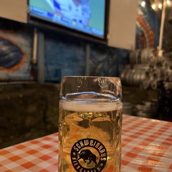 Schweinhaus Biergarten - a glass of beer on a table - German Near Me - Bellingham, Washington Schweinhaus Biergarten - a glass of beer on a table - German Near Me - Bellingham, Washington