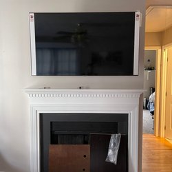 MSquared Solutions - TV hung on wall over over fireplace.