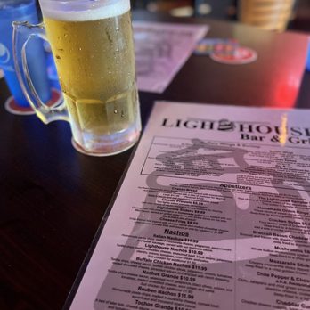 Lighthouse Bar & Grill - a glass of beer on a table - Sports Bars Near Me - Omaha, Nebraska