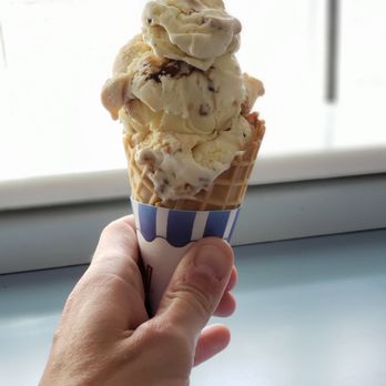 Moo Moo's Ice Cream - a hand holding a cone of ice cream - Ice Cream & Frozen Yogurt Near Me - St. John's, Newfoundland and Labrador Moo Moo's Ice Cream - a hand holding a cone of ice cream - Ice Cream & Frozen Yogurt Near Me - St. John's, Newfoundland and Labrador