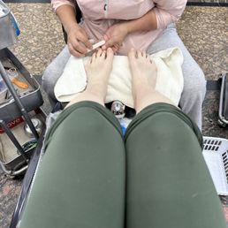 Nail tech working on feet. Nail tech working on feet.