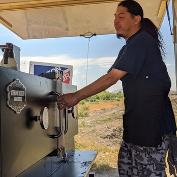 J'S Smokehouse Bbq - a man filling a beer from a bbq machine - Food Trucks Near Me