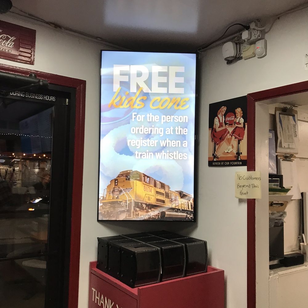 Taylors - a tv screen with a free train advertisement on it - Burgers Near Me - Loomis, California Taylors - a tv screen with a free train advertisement on it - Burgers Near Me - Loomis, California