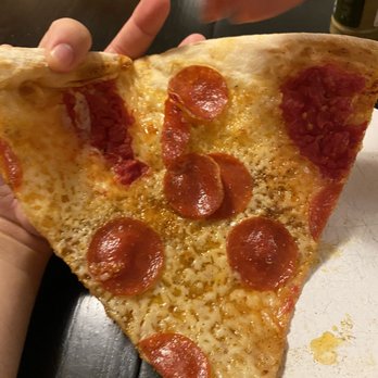 OTTO - a person holding a slice of pepperoni pizza - Pizza Near Me - Arlington, Massachusetts OTTO - a person holding a slice of pepperoni pizza - Pizza Near Me - Arlington, Massachusetts