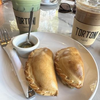 Tortoni Caffe - Iced Strawberry Mocha latte, iced matcha latter, chicken empanada, and ham & cheese empanada - Coffee & Tea Near Me - Sherman Oaks, California