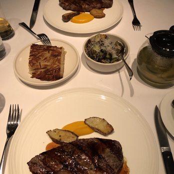 Elisa - Holstein striploin (top) and dry-aged striploin (bottom) with sides of hash browns and brussel sprouts - Steakhouses Near Me - Vancouver, British Columbia Elisa - Holstein striploin (top) and dry-aged striploin (bottom) with sides of hash browns and brussel sprouts - Steakhouses Near Me - Vancouver, British Columbia