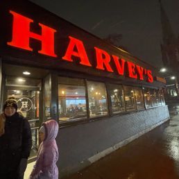 a woman and a man standing in front of a restaurant
