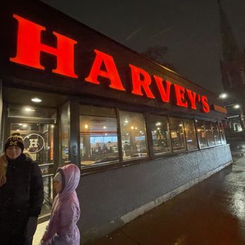 Harvey's - a woman and a man standing in front of a restaurant - Fast Food Near Me - Toronto, Ontario