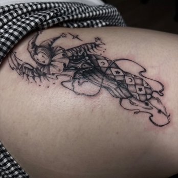 The Collective Tattoo - jester tattoo on side of thigh - Tattoo Near Me - Apple Valley, California