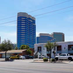 We're located in the two-story white building on the south side of Thomas between first and third Avenue