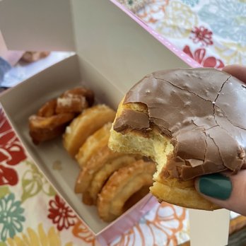 Coco Donuts - Portland - a hand holding a half eaten donut - Donuts Near Me - Portland, Oregon Coco Donuts - Portland - a hand holding a half eaten donut - Donuts Near Me - Portland, Oregon