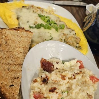 Another Broken Egg Cafe - The Floridian Omelette & city grits. She doesn't even like grits, but loved these! - Breakfast & Brunch Near Me - Destin, Florida Another Broken Egg Cafe - The Floridian Omelette & city grits. She doesn't even like grits, but loved these! - Breakfast & Brunch Near Me - Destin, Florida
