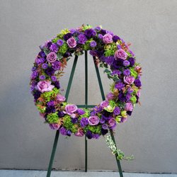 Michael's Flowers - Funeral wreath, purple, green , tiny accents of greenery with orange tips, succulents. Custom order.