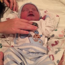 Breath of Life Birth Center - Baby is peaceful during an exam soon after birth at Breath of Life.