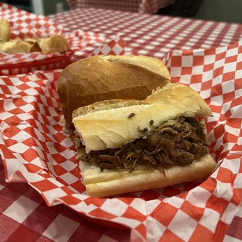 Roma Imports - a pulled pork sandwich in a basket - Italian Near Me - Tucson, Arizona Roma Imports - a pulled pork sandwich in a basket - Italian Near Me - Tucson, Arizona