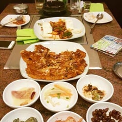 Bi Won - Kimchi soup, pan fried pork with tofu, kimchi seafood pancake, and assortment of side dishes.