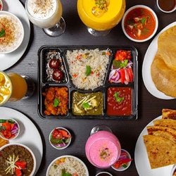 Veg Thali with 3 Curries, Rice, Rotis or Poori and sweet n salad.