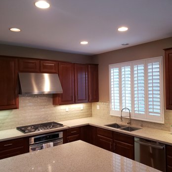 Pacific Surface - a kitchen with a sink, stove, and oven - Flooring Near Me